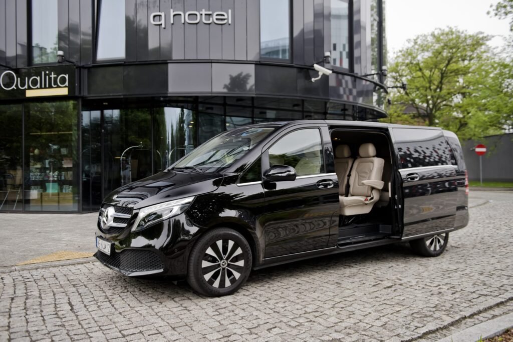 Luxury chauffeur services with a professional chauffeur standing beside a Mercedes-Benz S-Class in Europe